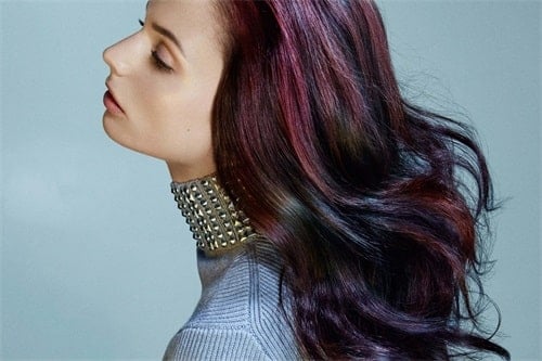 The oil slick hair color incorporates dark, iridescent tones of blue, purple, magenta, green and red. 